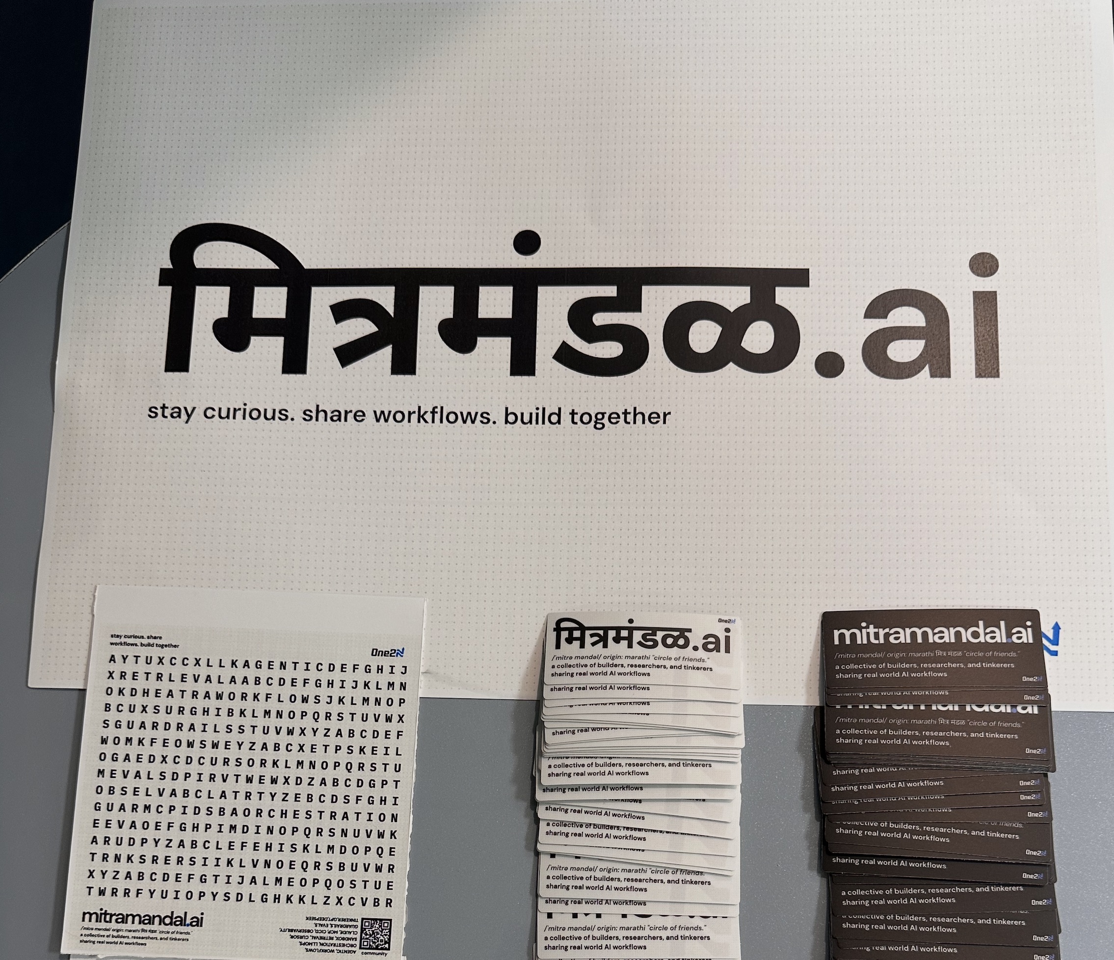 mitramandal.ai promotional materials, word search puzzle, and branded cards